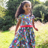 A child wearing the Frugi Bunny Bounce Issey Party Skater Dress