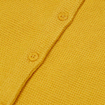 A close up of the Frugi yellow organic knitted cotton cardigan which features yellow buttons