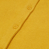 A close up of the Frugi yellow organic knitted cotton cardigan which features yellow buttons