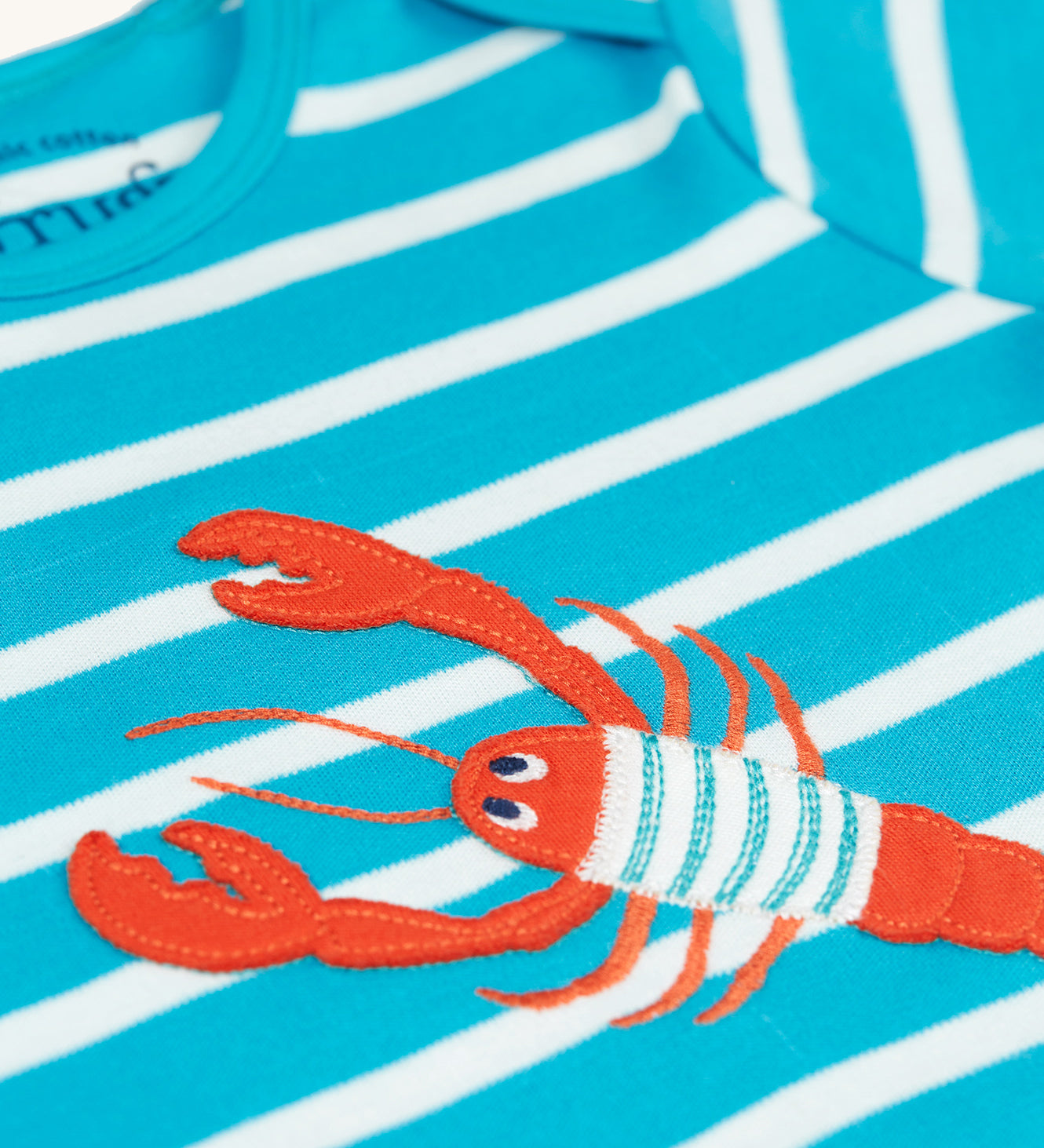  with poppers along the crotch. The lobster is also wearing a blue and white stripy top too!