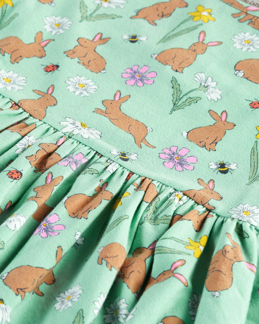  flower and insect print. The print of the dress shows light brown rabbits