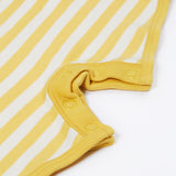 Close up of the Frugi kids crocodile rue romper. Showing the poppers on the inside of the legs for easy fitting on yellow and white striped organic cotton fabric