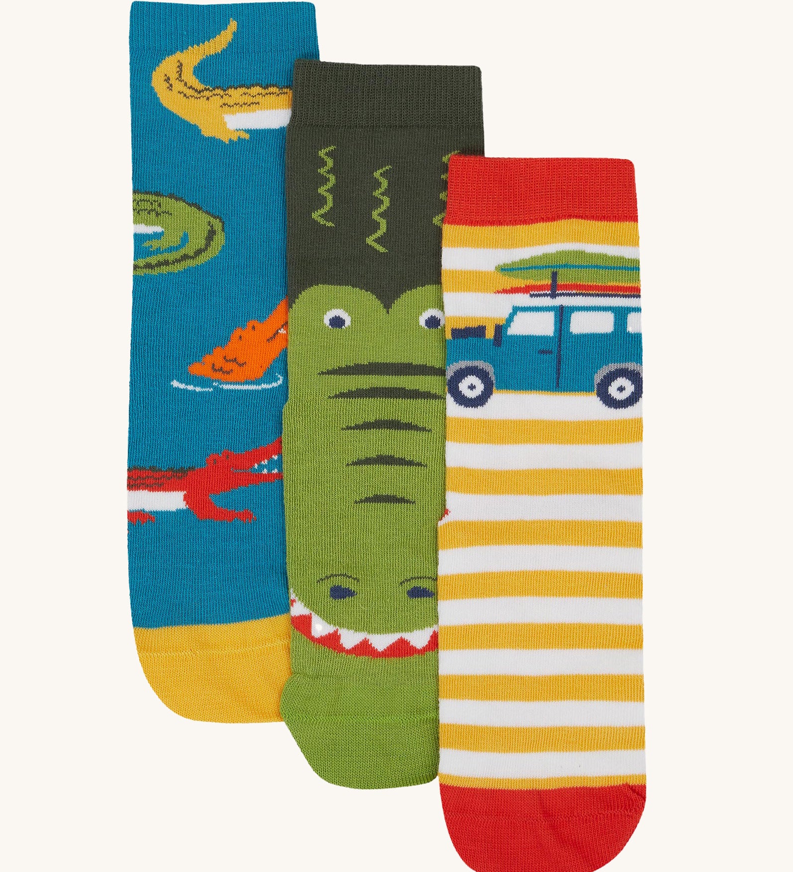 Frugi kids crocodile rock my socks 3 pack - GOTS organic cotton socks which features a teal sock with crocodiles, a green crocodile sock and a yellow and white stripe sock with a campervan.