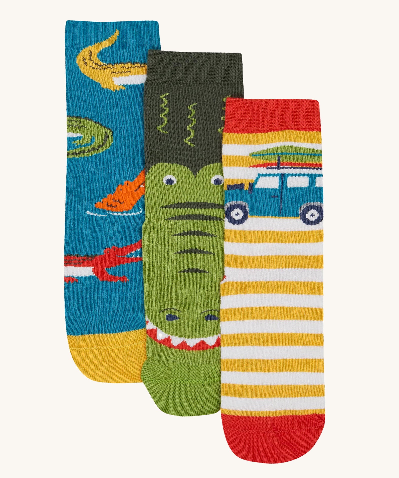 Frugi kids crocodile rock my socks 3 pack - GOTS organic cotton socks which features a teal sock with crocodiles, a green crocodile sock and a yellow and white stripe sock with a campervan.