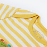 Close up of the Frugi kids crocodile rue romper. Showing the shoulder detail on yellow and white striped organic cotton fabric