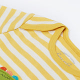 Close up of the Frugi kids crocodile rue romper. Showing the shoulder detail on yellow and white striped organic cotton fabric