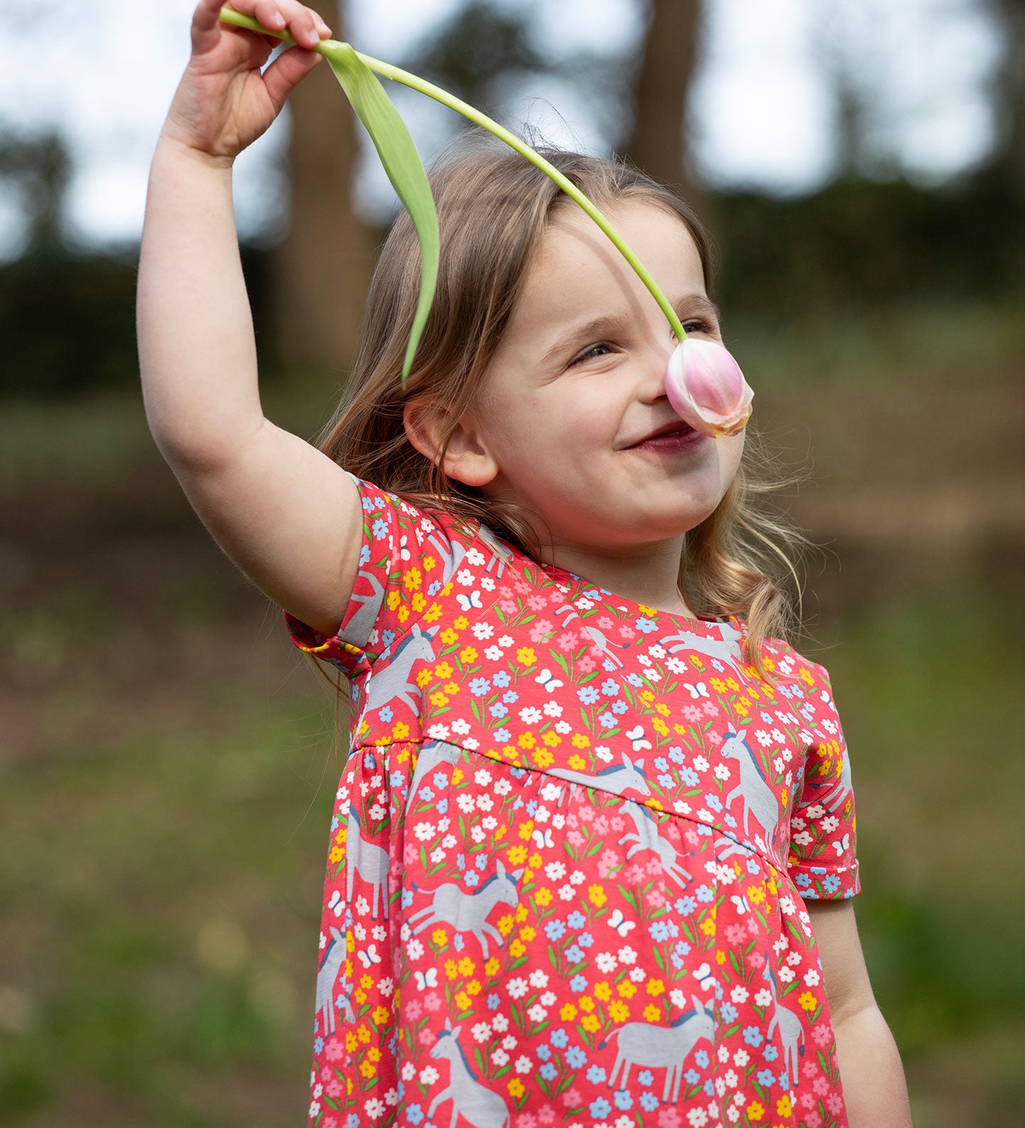 A child wearing the Frugi Donkey Drove Ellen Dress. 