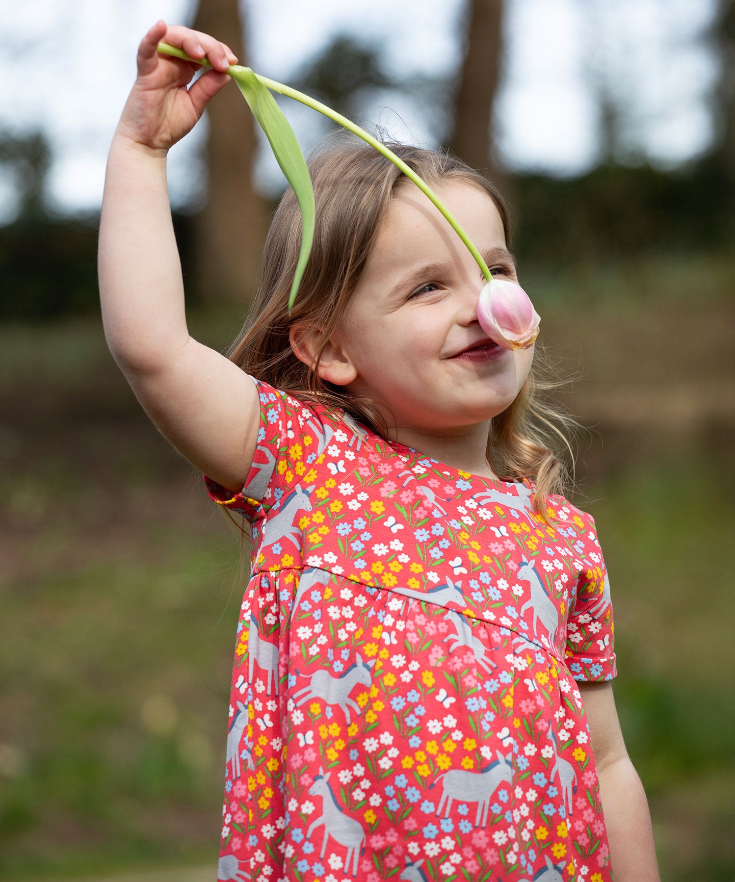 A child wearing the Frugi Donkey Drove Ellen Dress. 