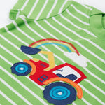 A close up of the Frugi kids breton easy on tractor jumper. Showing a short sleeve, green neck trim, red tractor applique and a rainbow embroidery on green and white stripe organic cotton fabric