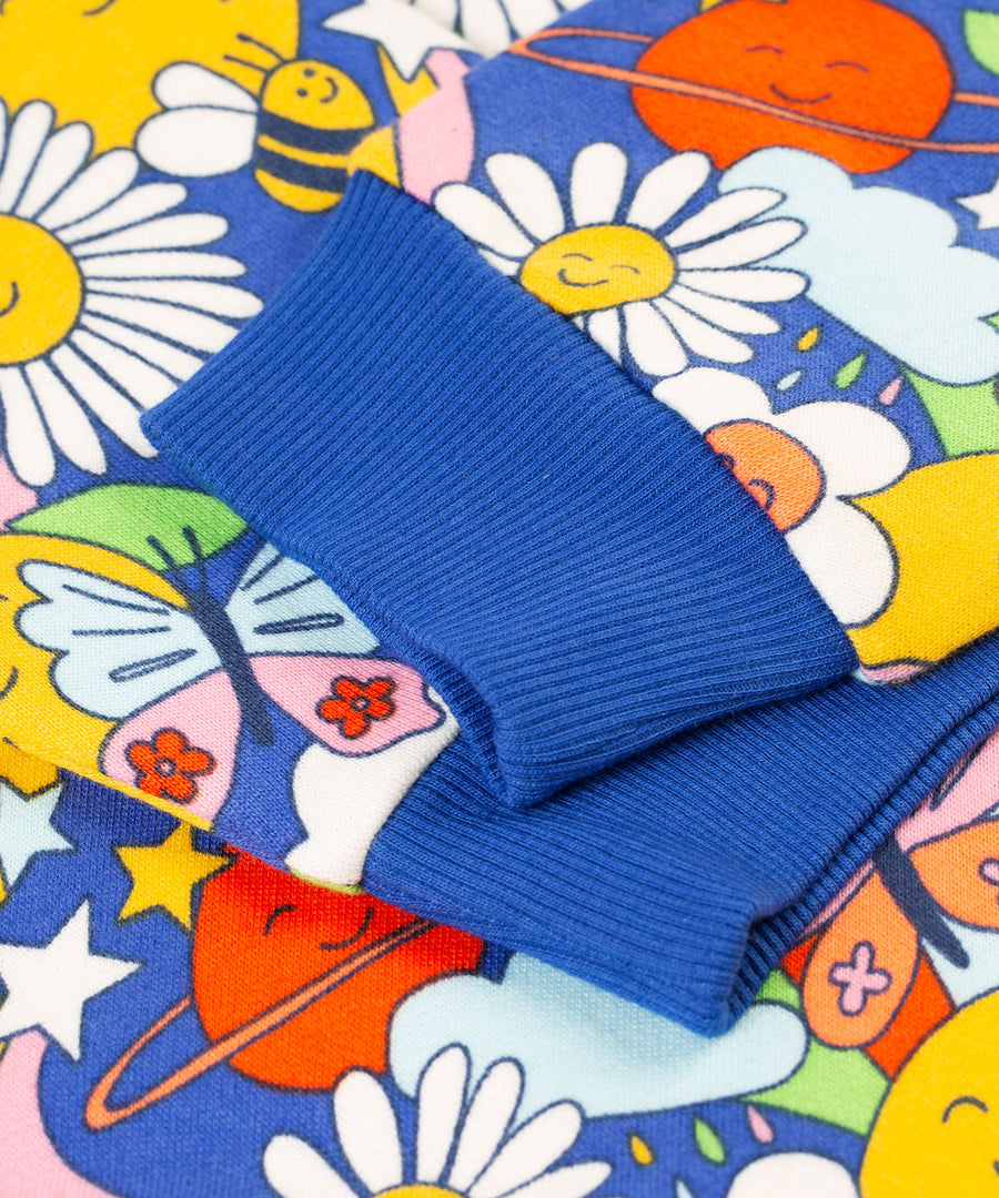 A close up of the cuffs on the sleeves of the Frugi Easy On kids Jumper with a Retro Happy print. 