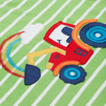 A close up of the Frugi kids breton easy on tractor jumper. Showing a red tractor applique and a rainbow embroidery on green and white stripe organic cotton fabric