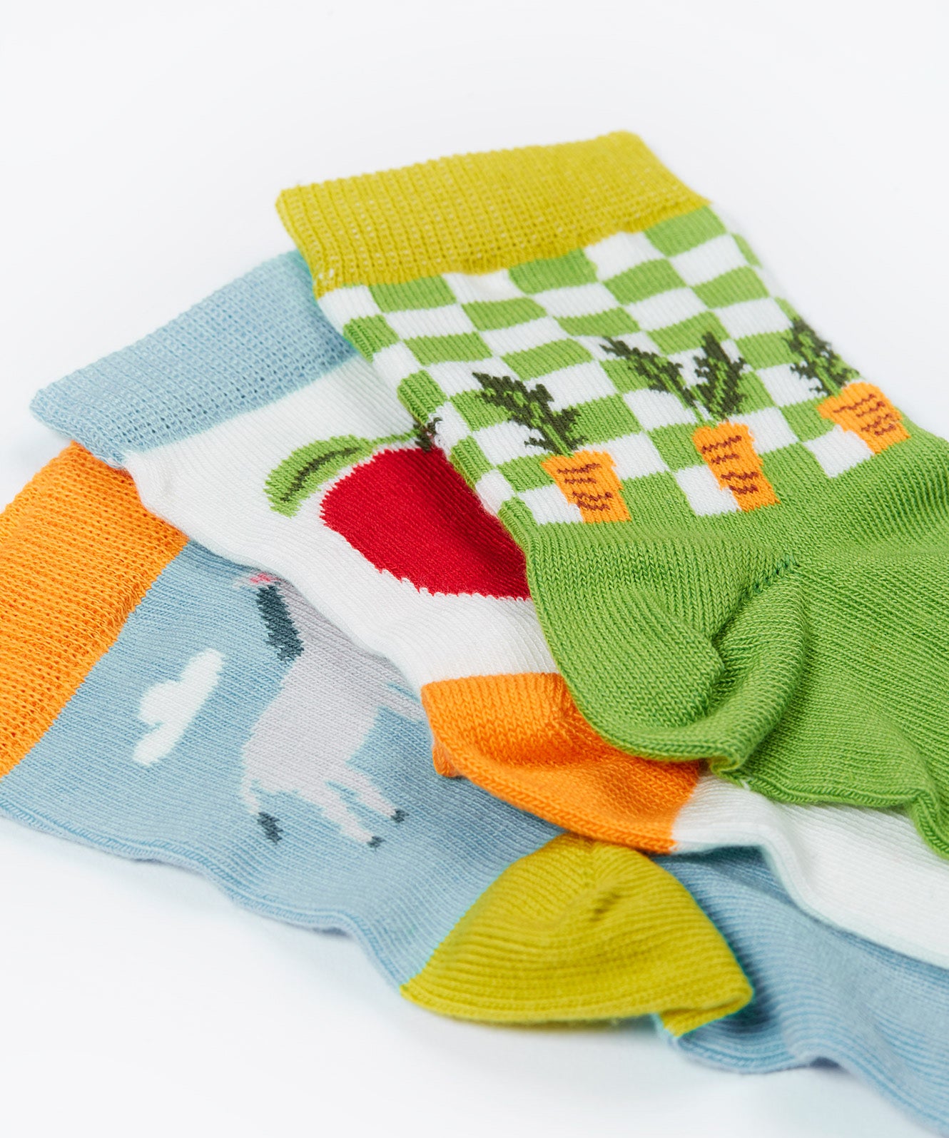 Close up of the Frugi baby farm field 3 pack socks. Showing the 3 unique and vibrant Frugi farm related prints with elasticated ankle cuffs on organic cotton fabric