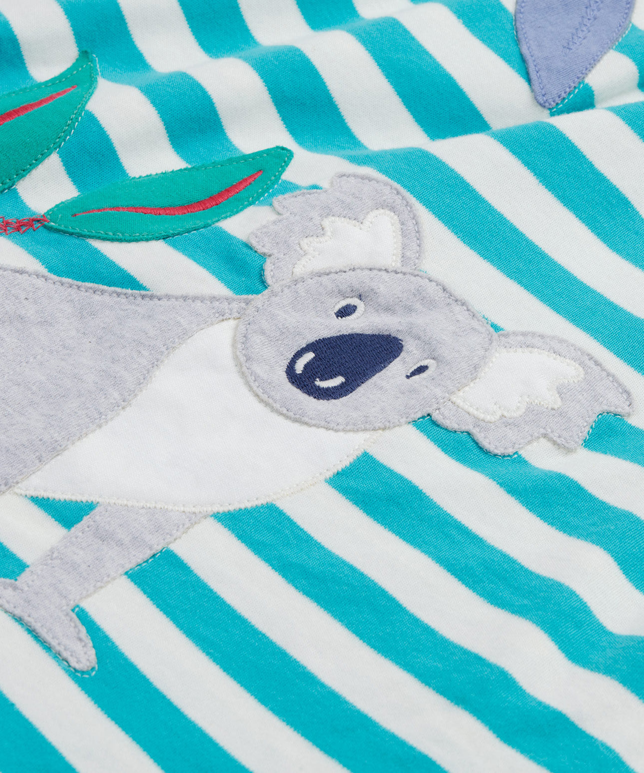 Close up of the Frugi kids Felicity koala dress. Showing the appliqué of a grey koala on white and light blue striped organic cotton fabric