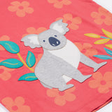 Close up of the Frugi kids flora fun koala t-shirt. Showing the appliqué of the grey koala next to coloured leaves on light pink organic cotton fabric with pastel orange floral prints