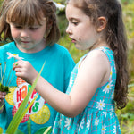 A child wearing the Frugi Floral Check organic cotton Summer Holiday Dress.