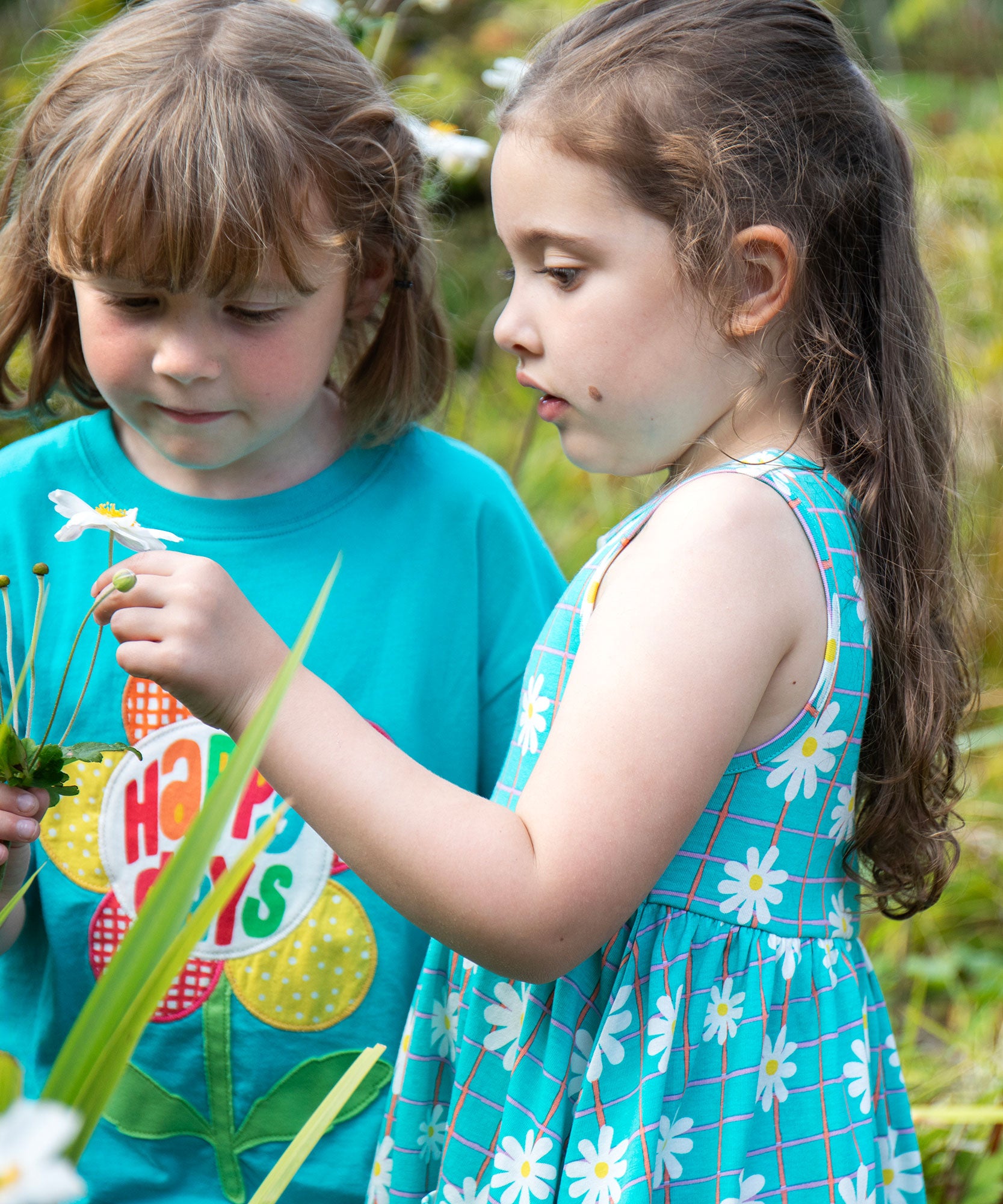 A child wearing the Frugi Floral Check organic cotton Summer Holiday Dress.