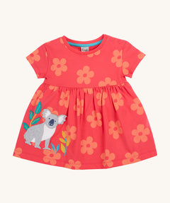 Frugi kids flora fun koala tunic top - GOTS organic cotton kids tunic top in light pink with pastel orange floral prints, short sleeves and popper fasteners on the shoulder for easy fitting. Features and applique of a grey koala next to bamboo shoots.