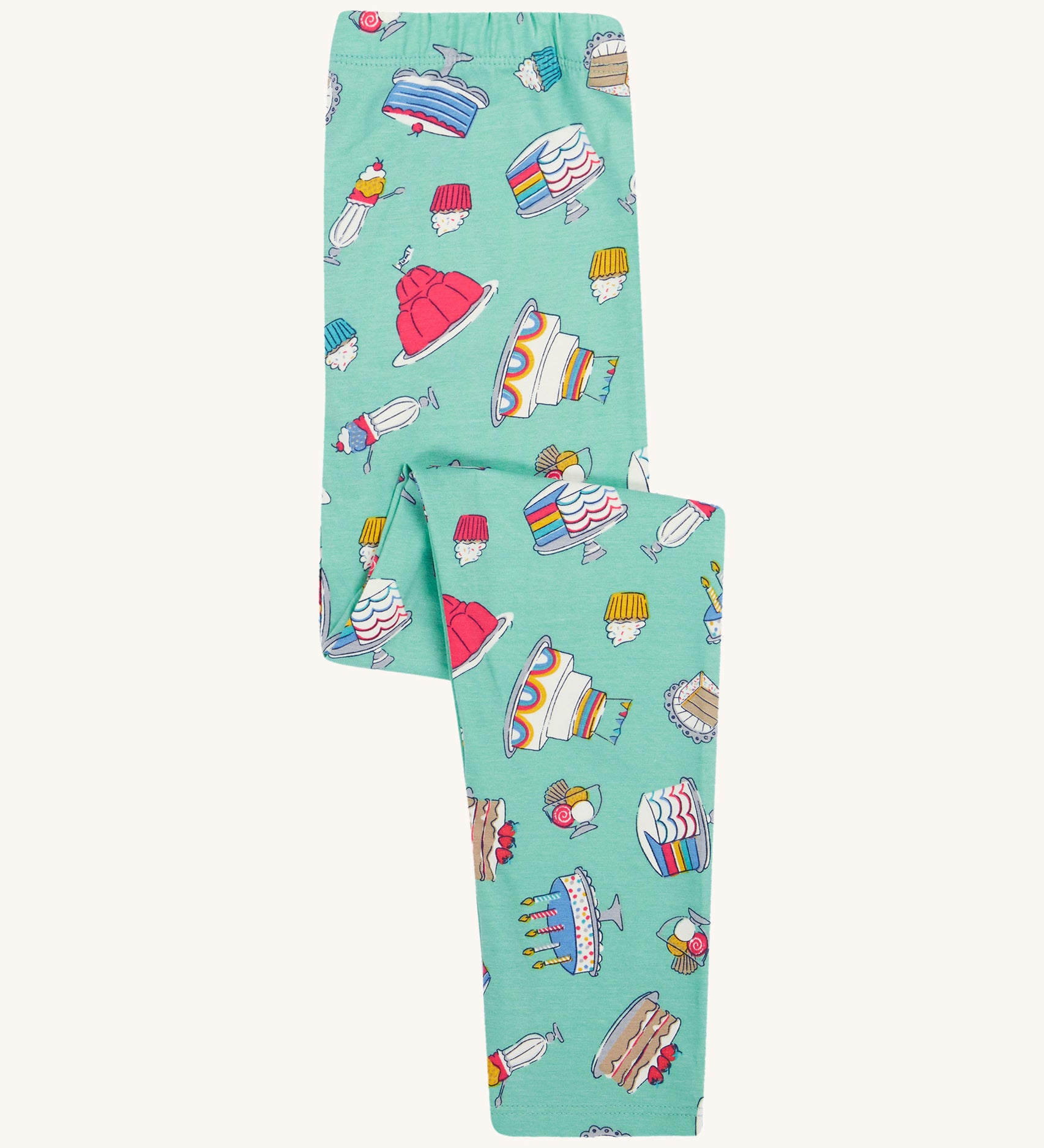 Frugi kids let's bake libby leggings - GOTS organic cotton light green leggings folded with different cakes, puddings and ice creams designs.