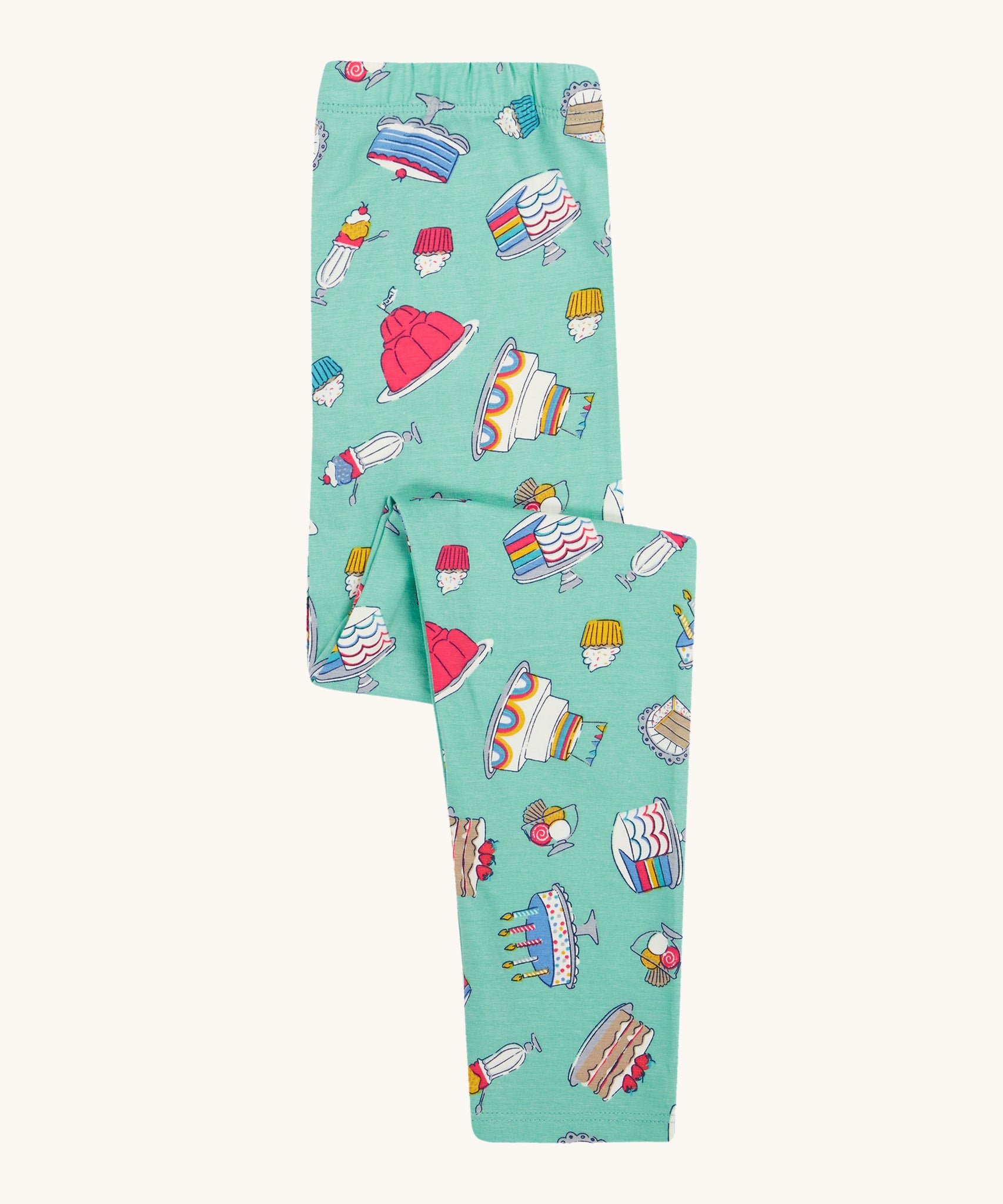 Frugi kids let's bake libby leggings - GOTS organic cotton light green leggings folded with different cakes, puddings and ice creams designs.