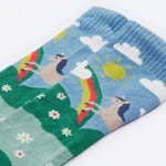 Close up on the Frugi kids hygge knee high sock showing horse in a field of daisies design on organic cotton fabric