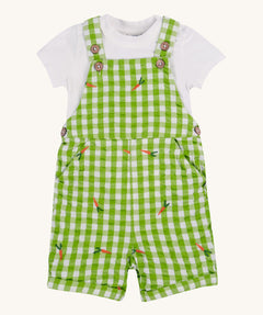 Frugi kids Alfred dungarees outfit, macaw gingham carrots - GOTS organic cotton kids dungaree outfit with a white short sleeve t-shirt and green gingham dungaree with button fasteners. Features orange carrots embroidery scattered on the dungaree. 