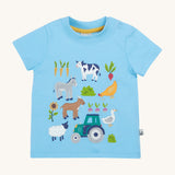 Frugi kids bluebird farm life t-shirt - GOTS organic cotton Frugi kids tshirt in light blue colour. Features a cow, donkey, hen, goat, sheep, goose, tractor, sunflower, carrot, radish and a beetroot appliqué. 