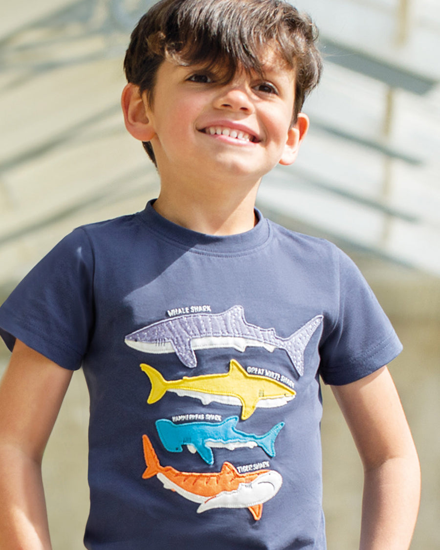  with four colourful sharks sewn onto the front. From top to bottom is a lilac whale shark