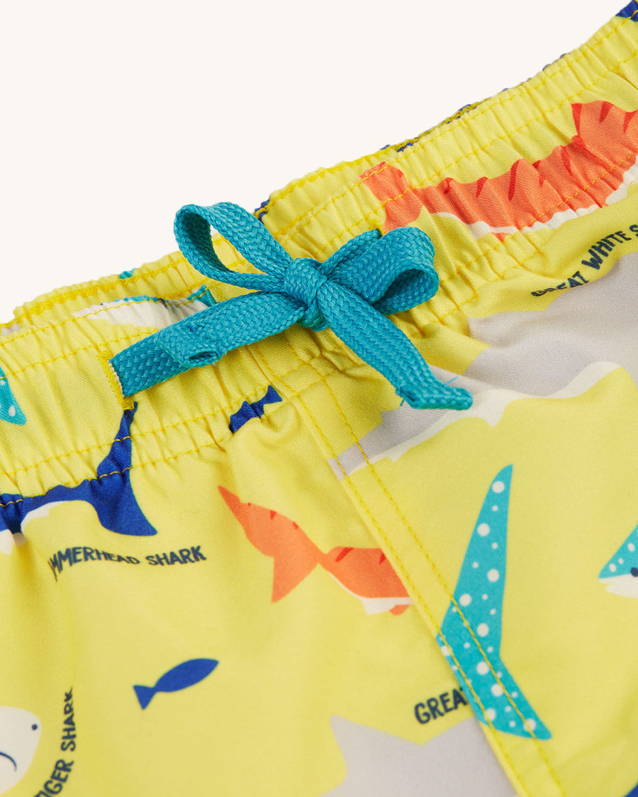  made from recycled bottles. A light banana yellow short with fun and colourful shark print