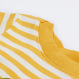 A close up of the Frugi kids wrap around crocodile outfit. Showing the yellow neck trim on yellow and white stripe organic cotton fabric