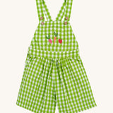 Frugi kids macaw gingham, veg Cassie culotte dungarees - GOTS organic cotton kids dungarees with green and white gingham, button fasteners on the shoulder straps for easy fitting with a front pouch pocket. Features an embroidery of  a beetroot, carrot and apple.