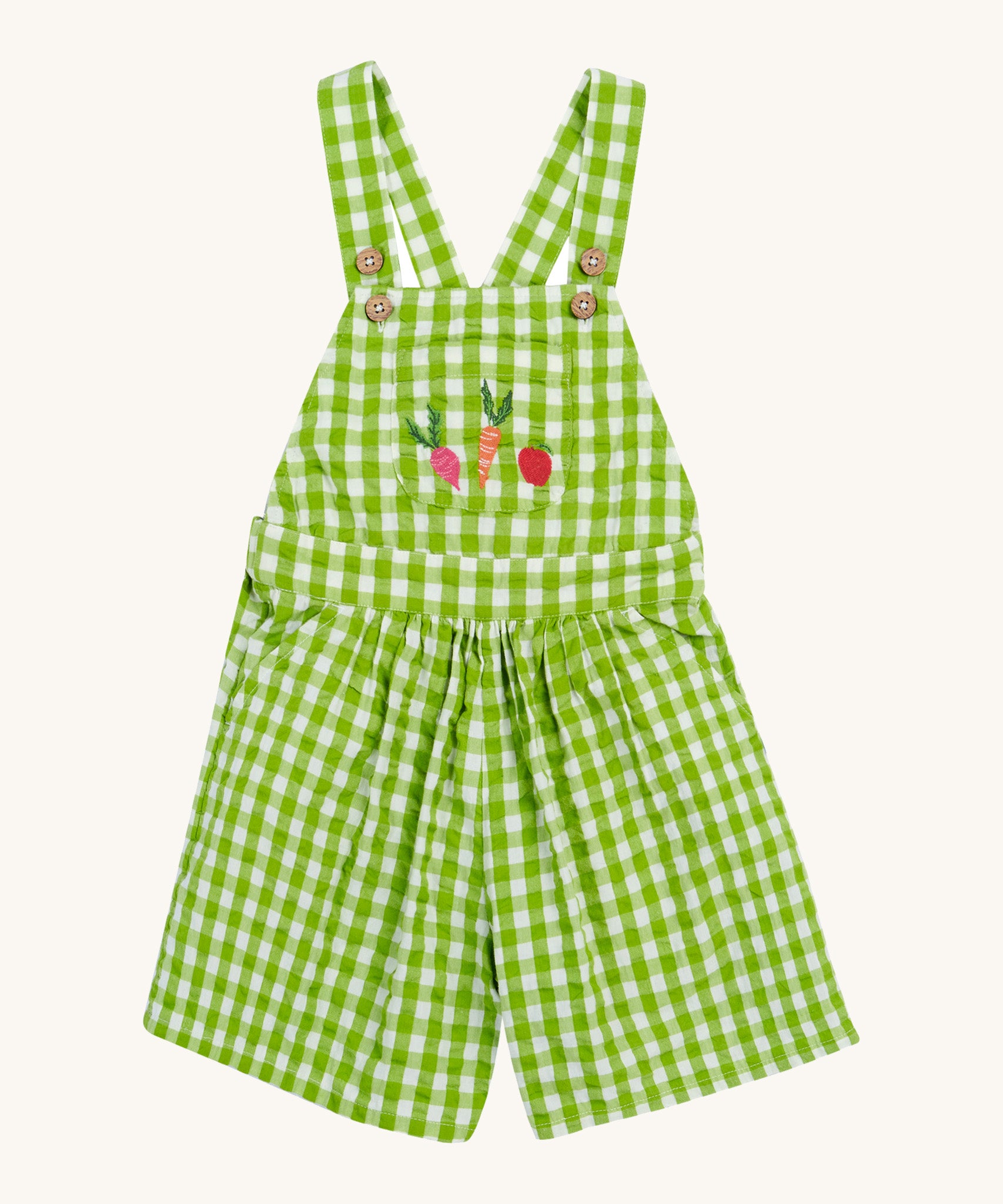 Frugi kids macaw gingham, veg Cassie culotte dungarees - GOTS organic cotton kids dungarees with green and white gingham, button fasteners on the shoulder straps for easy fitting with a front pouch pocket. Features an embroidery of  a beetroot, carrot and apple.