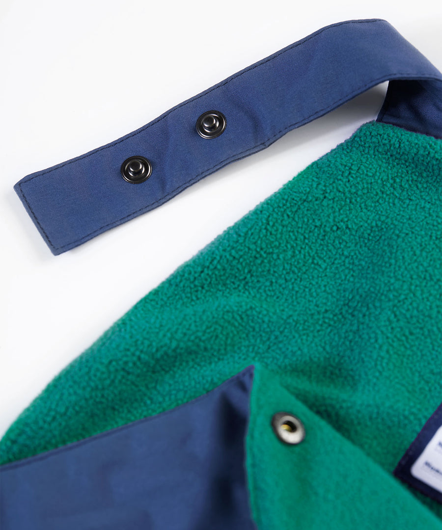 A closer look at the green fleece inner lining and name label on the Frugi Children's Little Waterproof Dungarees - Navy Blue