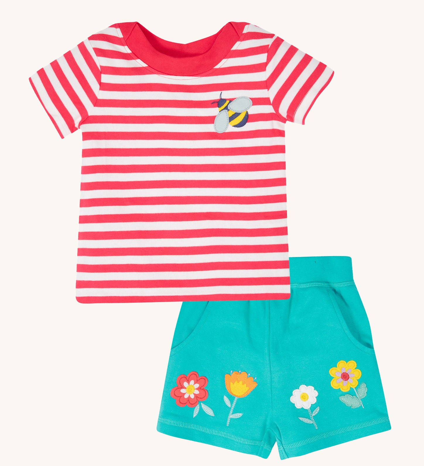 Frugi kids easy on bee outfit - GOTS organic cotton kids outfit features a  light pink tshirt with white stripes, short sleeve, light pink neck trim and a bee applique on the chest. Light blue shorts with applique flowers. 