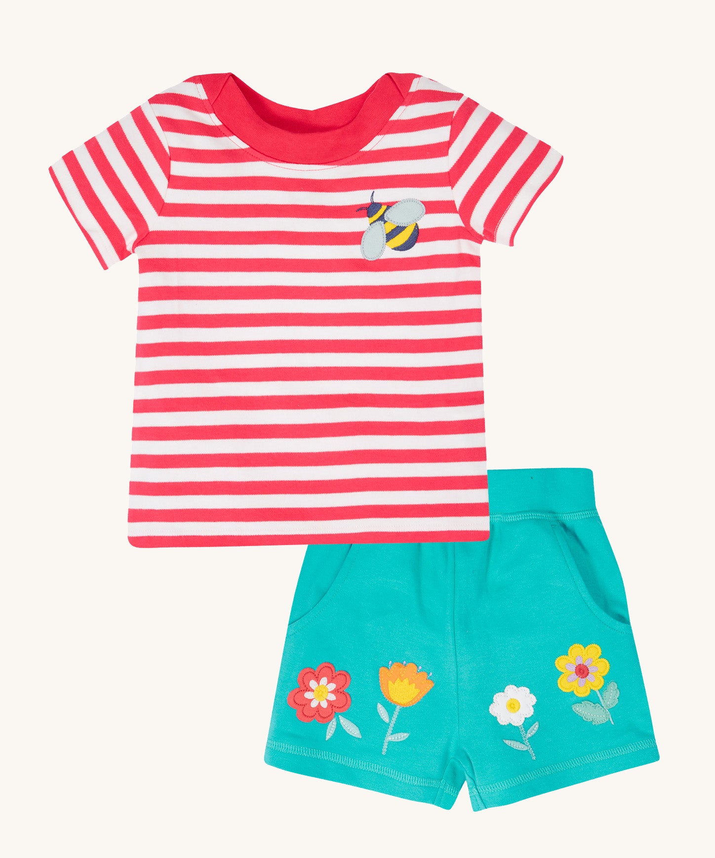 Frugi kids easy on bee outfit - GOTS organic cotton kids outfit features a  light pink tshirt with white stripes, short sleeve, light pink neck trim and a bee applique on the chest. Light blue shorts with applique flowers. 