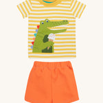 Frugi kids easy wrap around crocodile outfit. GOTS organic cotton Frugi kids outfit with a yellow and white stripe, short sleeve t-shirt, yellow neck trim and orange short. Features a crocodile eating a ice applique on the front of the t-shirt