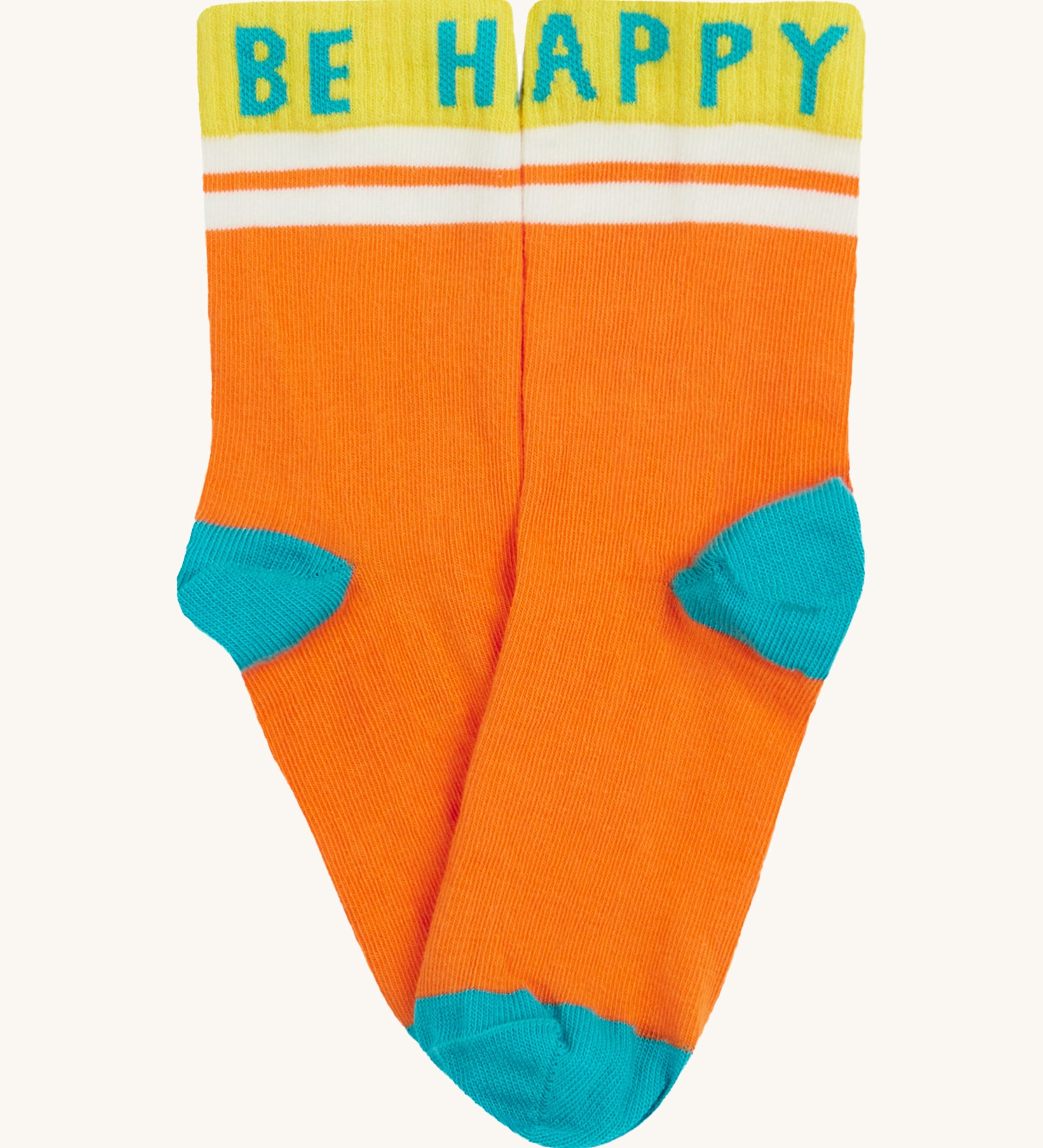 Close up of the Frugi orange sunnie socks. Showing the Be Happy slogan on the ankle cuff. Features a light blue heel and toe contrast panel on orange organic cotton fabric