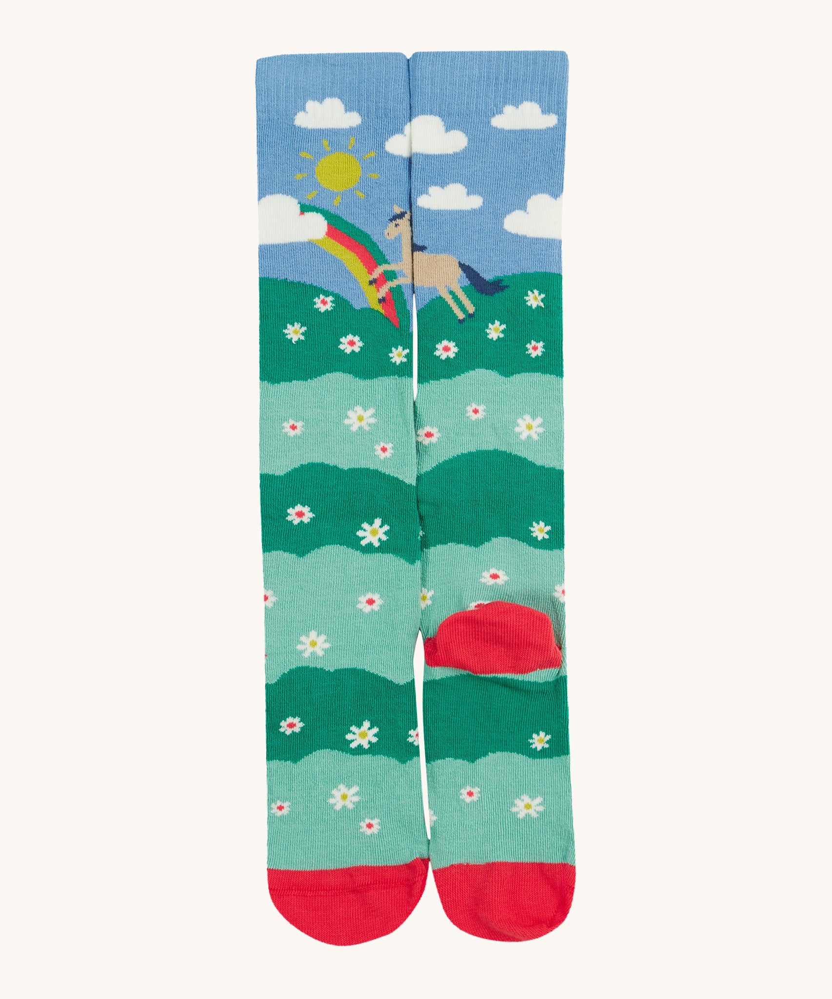 Frugi kids hygge knee high sock showing horse in a field of daisies design with toe and heel panel sock on organic cotton fabric