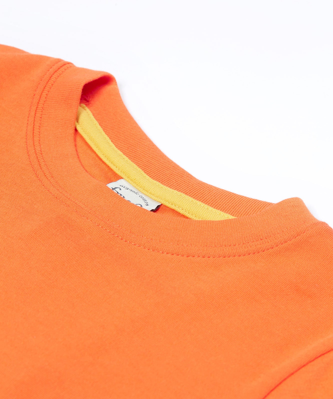 Close up of the Frugi kids orange koala t-shirt. Showing theorange neck trim with light yellow trim on the inside of the neck on orange organic fabric