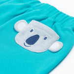 Close up of the Frugi kids koala shorts showing the grey koala back pocket detail on light blue organic cotton fabric