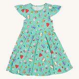 Frugi kids lets bake Morwenna skater dress - GOTS organic cotton Frugi skater dress in light green, short sleeves and a gentle frill. Features different prints of  cakes, ice creams and puddings.