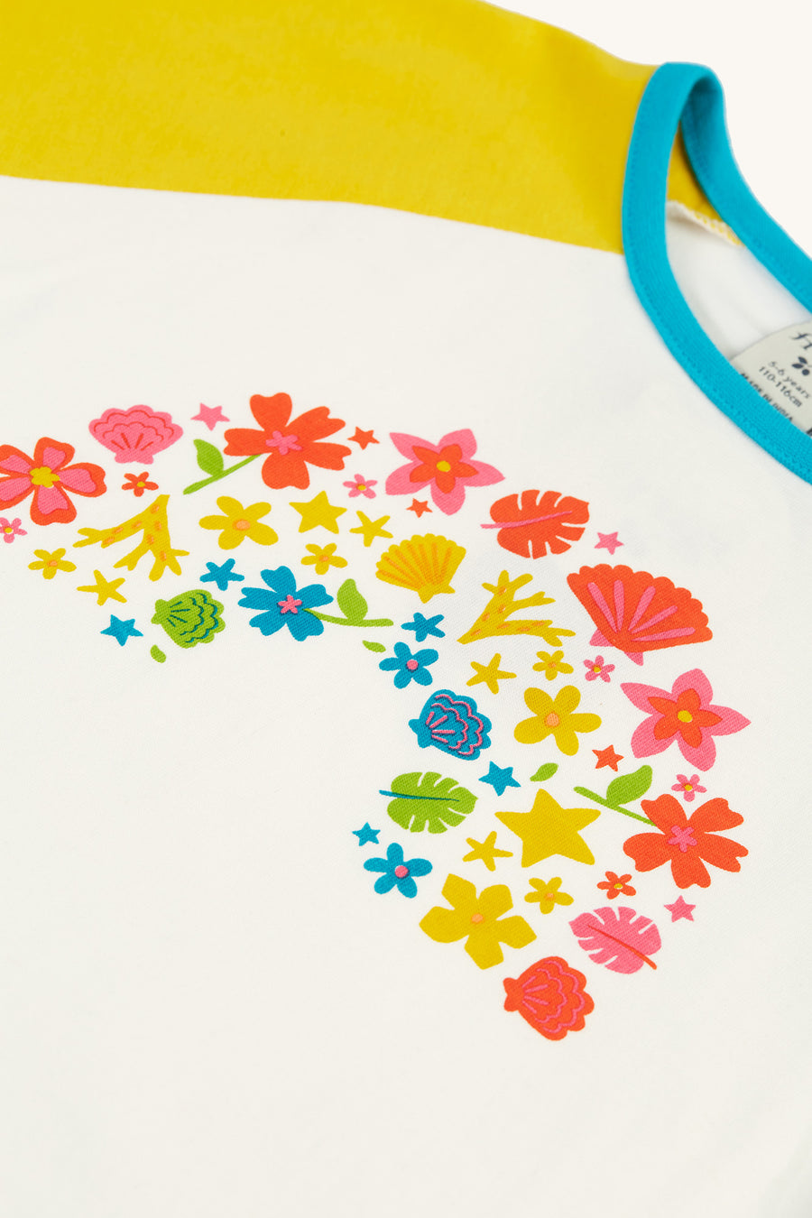  and features a colourful floral rainbow graphic on the front in flower blooms