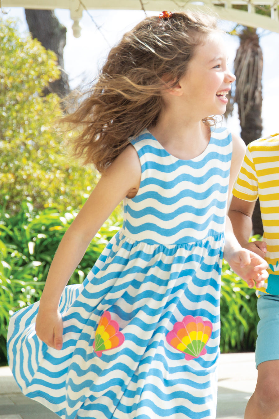 A child happily playing in the sun