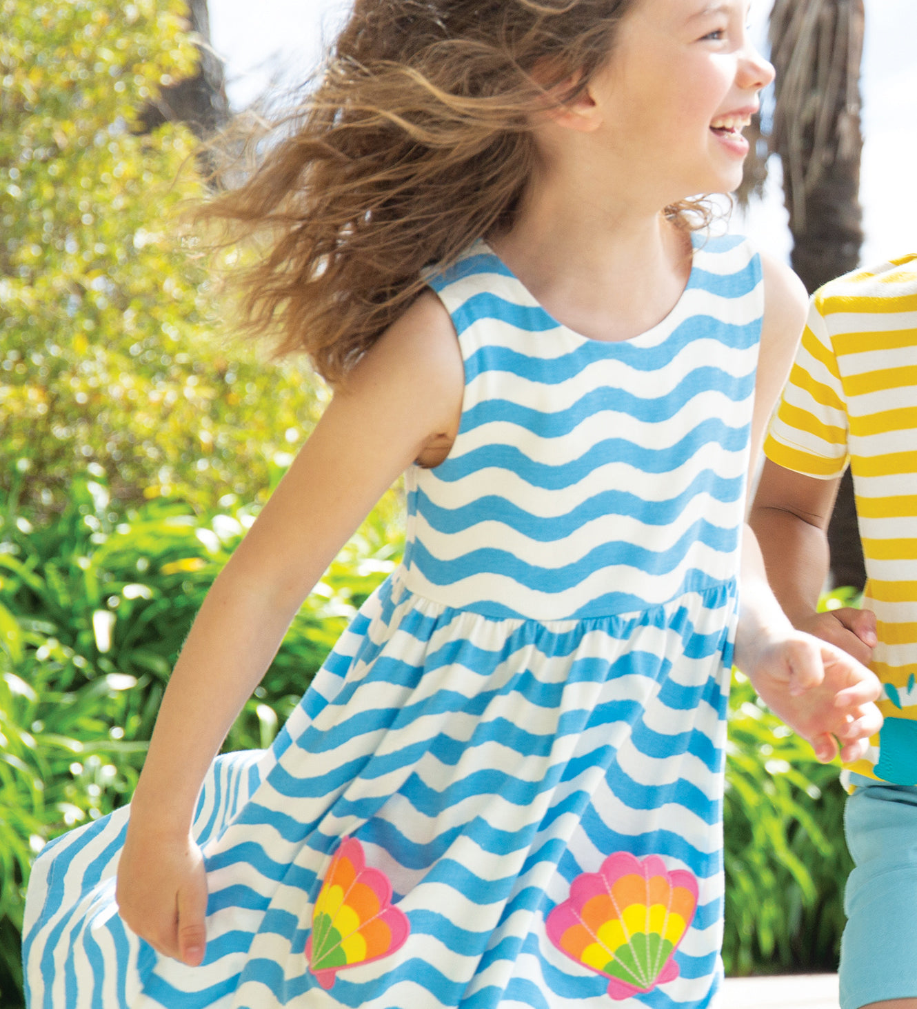 A child happily playing in the sun