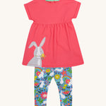 Frugi kids watermelon iris bunny outfit - GOTS organic cotton kids outfit including a light pink top with short sleeves and a grey rabbit appliqué with light blue bottoms with white rabbits and floral prints. 