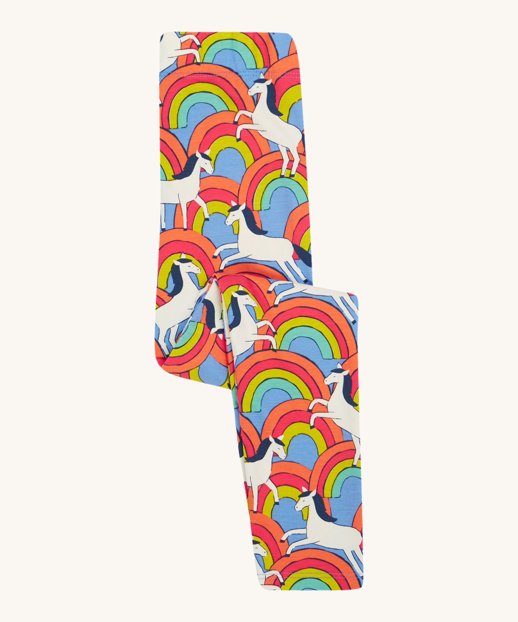 Frugi kids over the rainbow leggings - GOTS organic cotton Frugi kids leggings   in light blue folded in half with white horses on top of bright multicoloured rainbows 