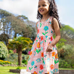 A child wearing the Frugi Kids Paint A Floral Delphi Dress.