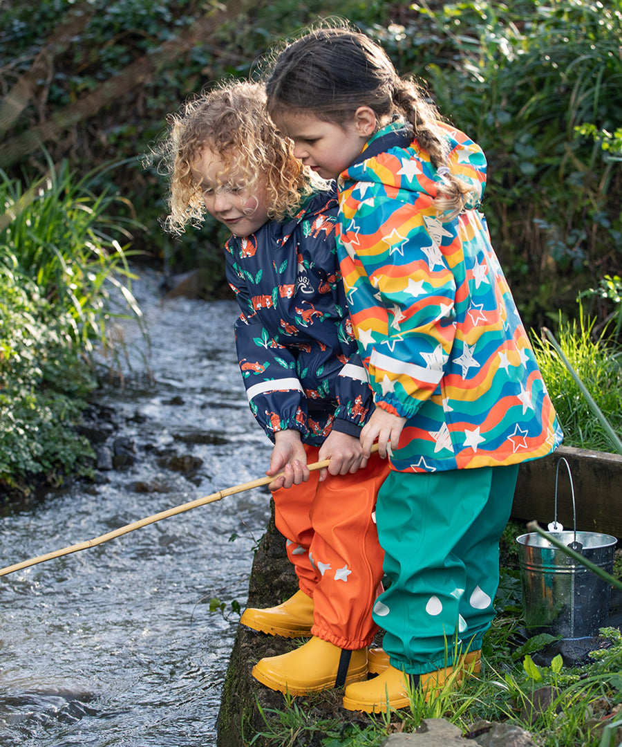 A closer look a the reflective raindrops on the Frugi Children's Puddle Buster Trousers - Iguana Turquoise