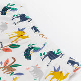 A close up of the Frugi kids snooze wildlife pyjama set showing the prints of different wild animals and elastic waist band on white organic cotton fabric