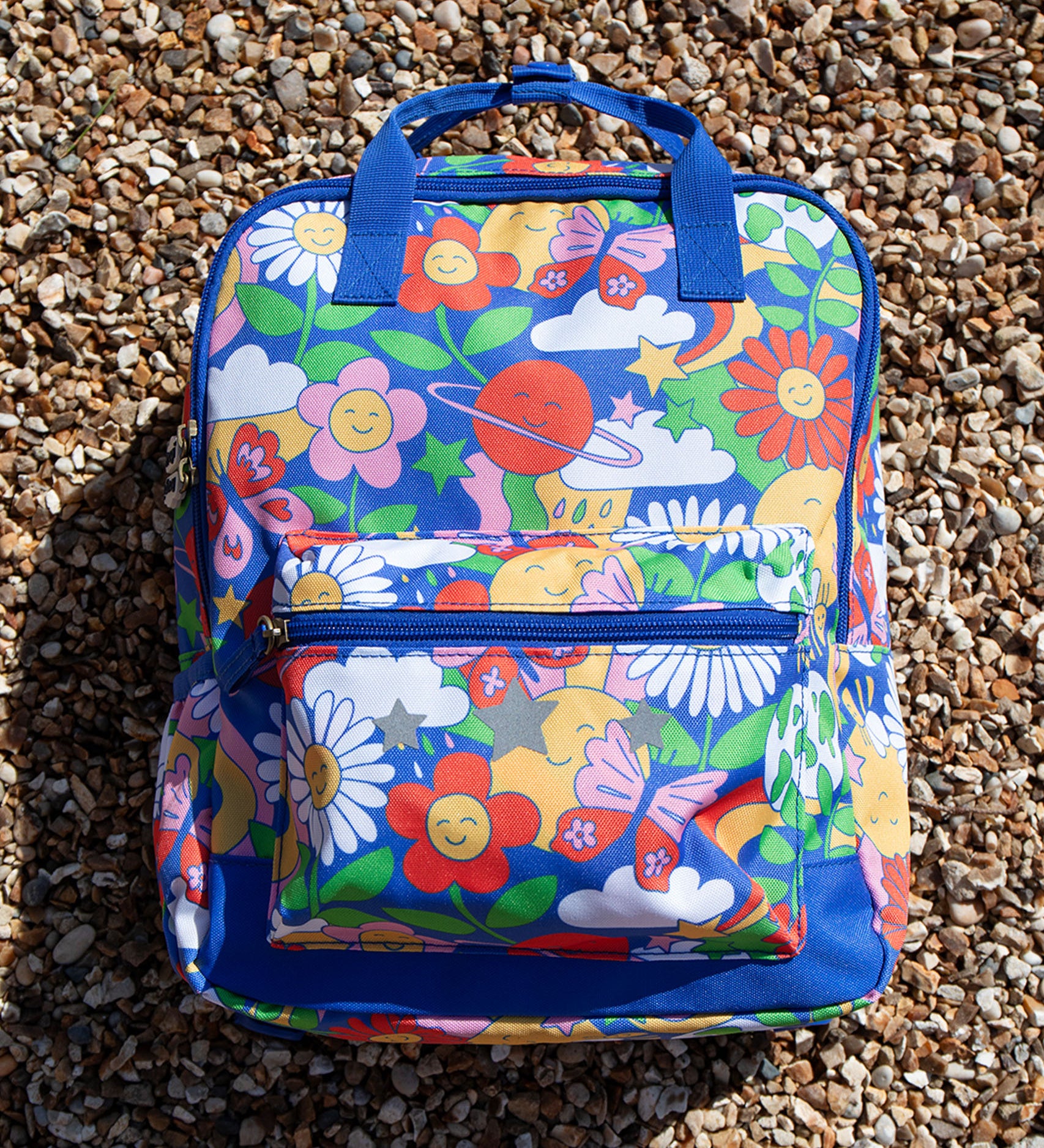  this Explorers Backpack from Frugi comes in a Retro Happy print featuring smiling planets