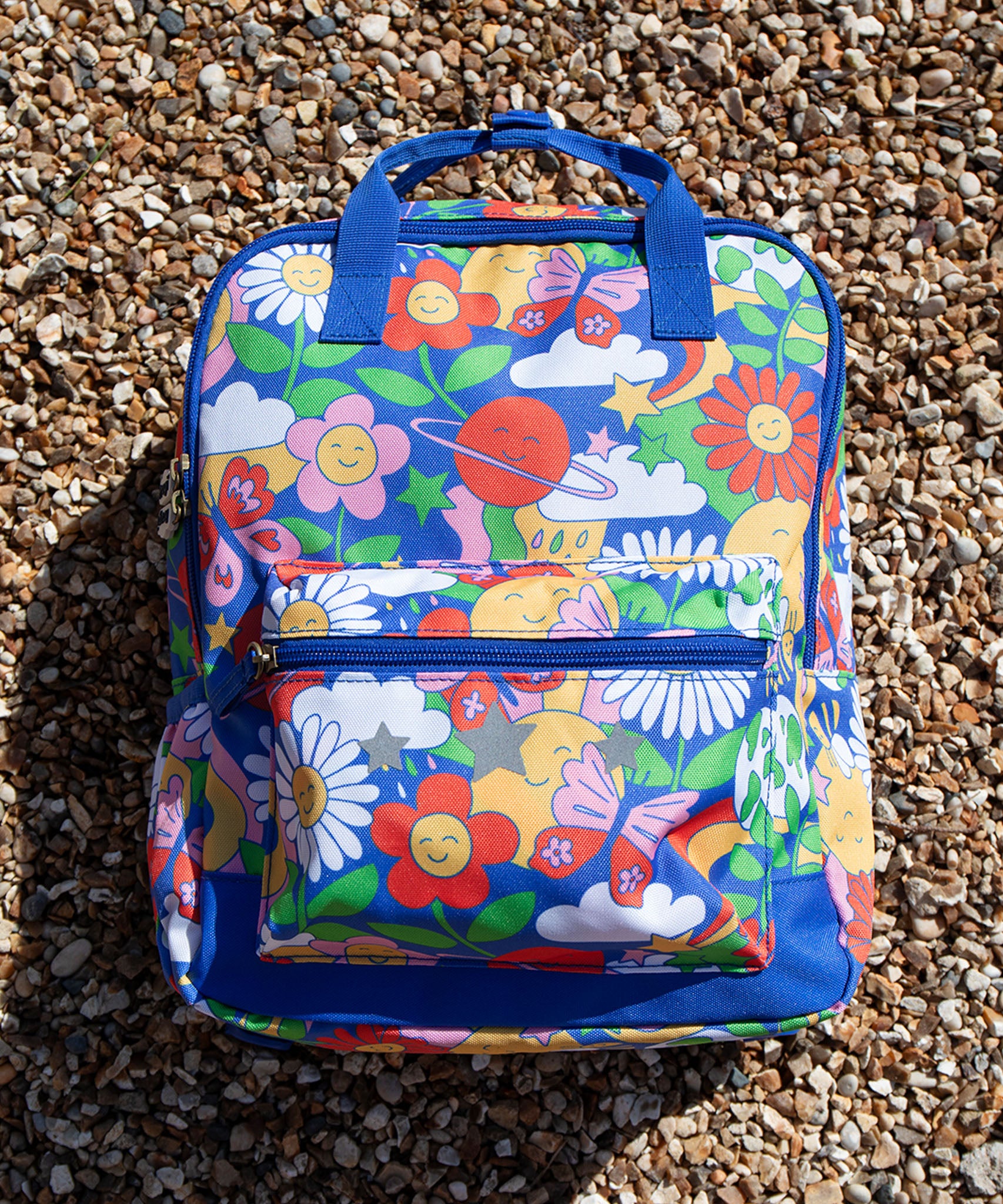  this Explorers Backpack from Frugi comes in a Retro Happy print featuring smiling planets